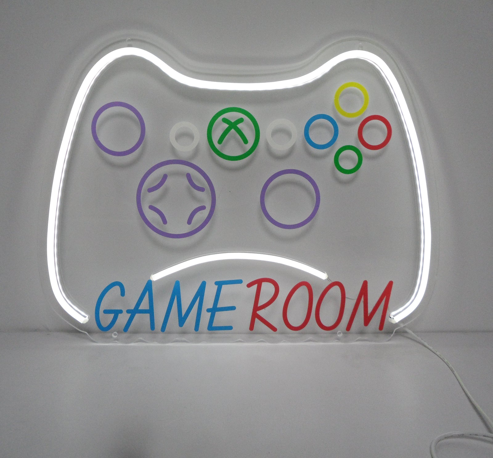 The fabricated game controller neon sign shown from a front angle, displaying the colorful outline and physical acrylic backing.