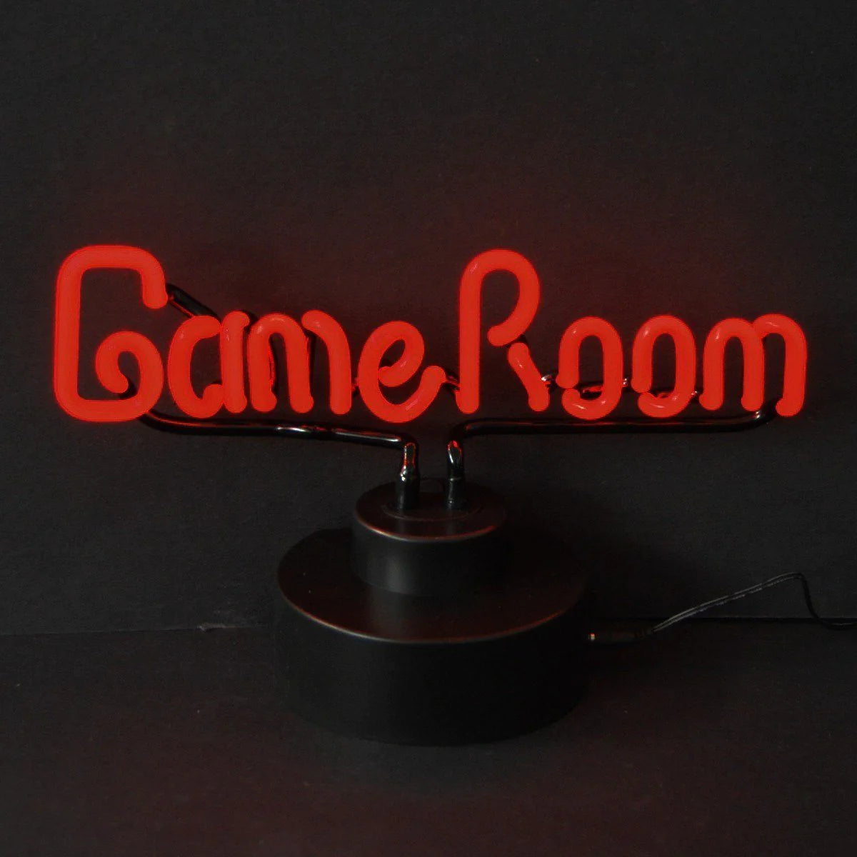 A table-top neon sign displaying 'GAME ROOM' in blue and white stylized letters, sitting against a black background.