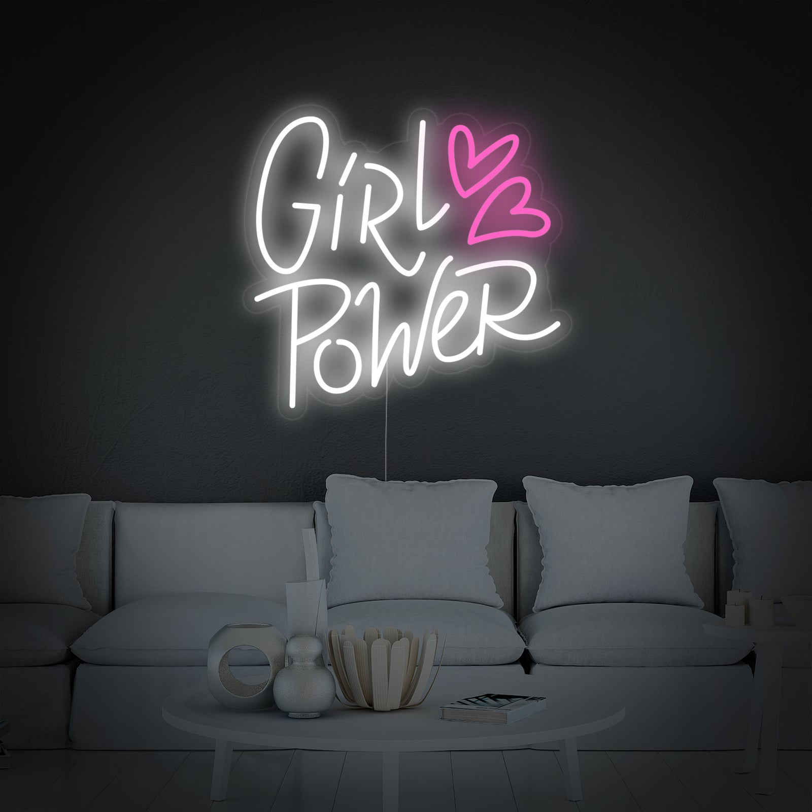 An styled conceptual design visualization of the 'Girl Power Hearts' neon sign glowing on a clean pink wall in a modern room setting.