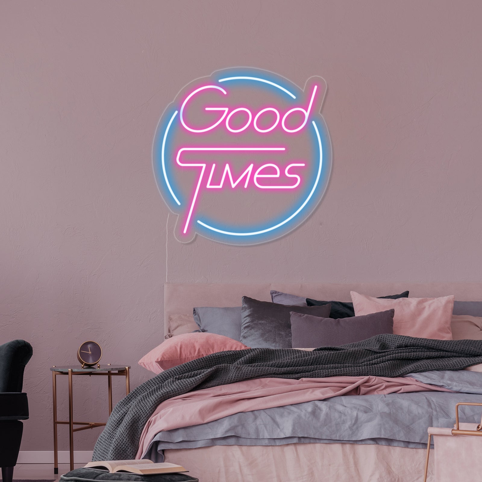 A vibrant 'Good Times' glowing neon sign in a cheerful font, mounted on an acrylic backboard within a stylish bedroom setting, providing warm ambient light.