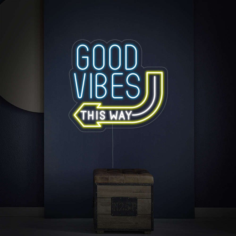 The 'Good Vibes This Way' neon sign mounted on a textured wall, showing its detailed tubing and backboard.