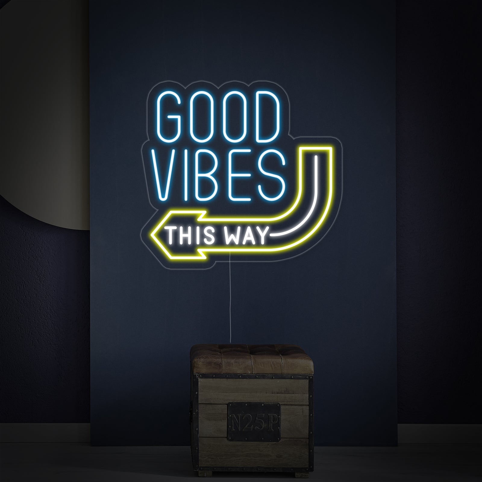 The 'Good Vibes This Way' neon sign mounted on a textured wall, showing its detailed tubing and backboard.