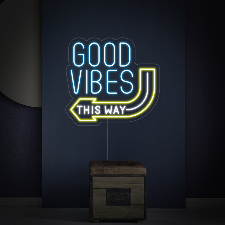 The 'Good Vibes This Way' neon sign mounted on a textured wall, showing its detailed tubing and backboard.