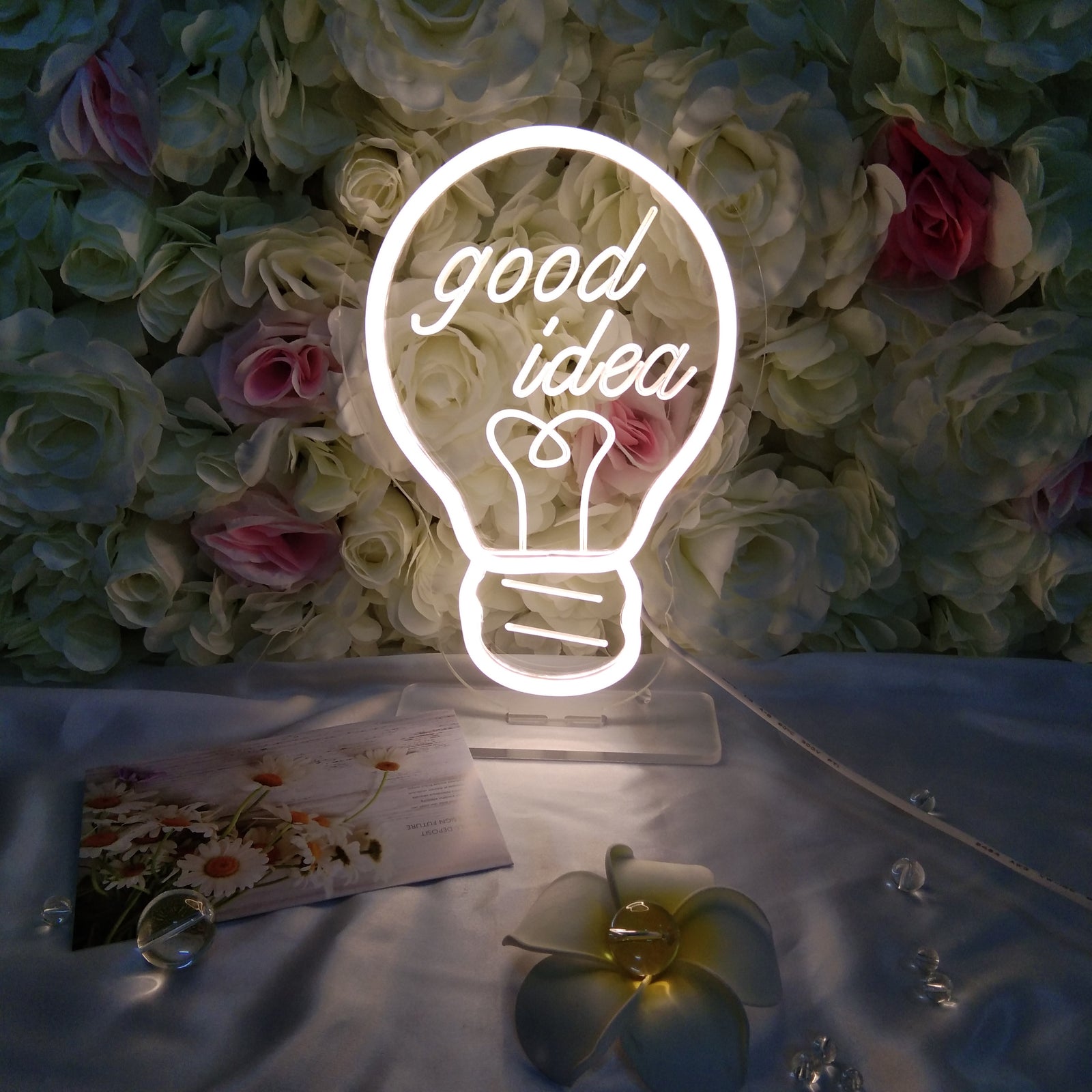 "Good Idea Bulb" neon sign on a clear acrylic backing