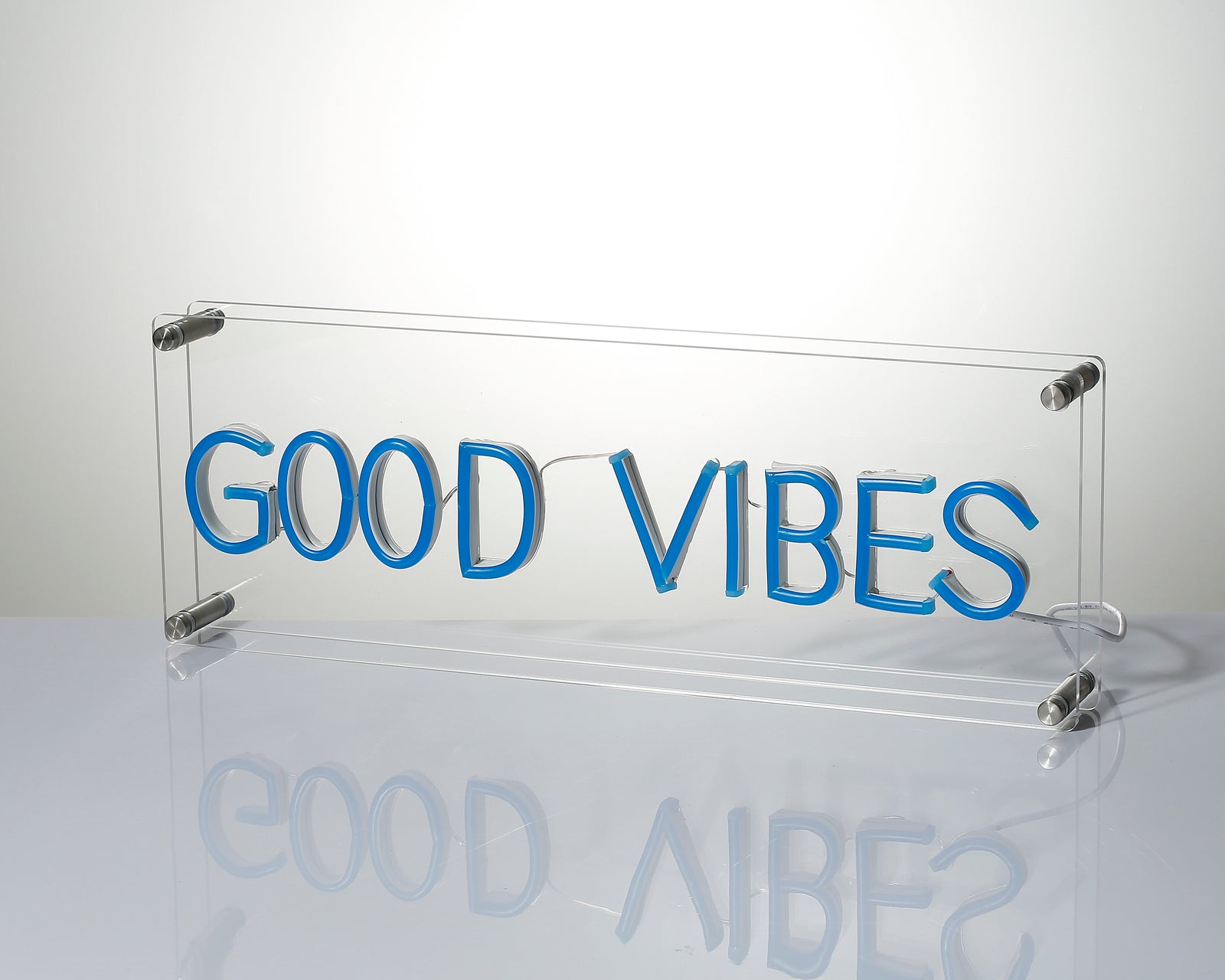 Close up of the illuminated 'Good Vibes' neon sign displaying the details of the lettering.