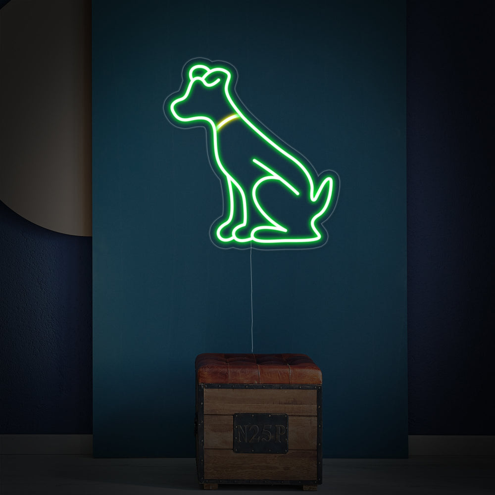A detailed product shot of the controller-shaped 'Green Dog' neon sign, showing the glow against a clear acrylic backing.