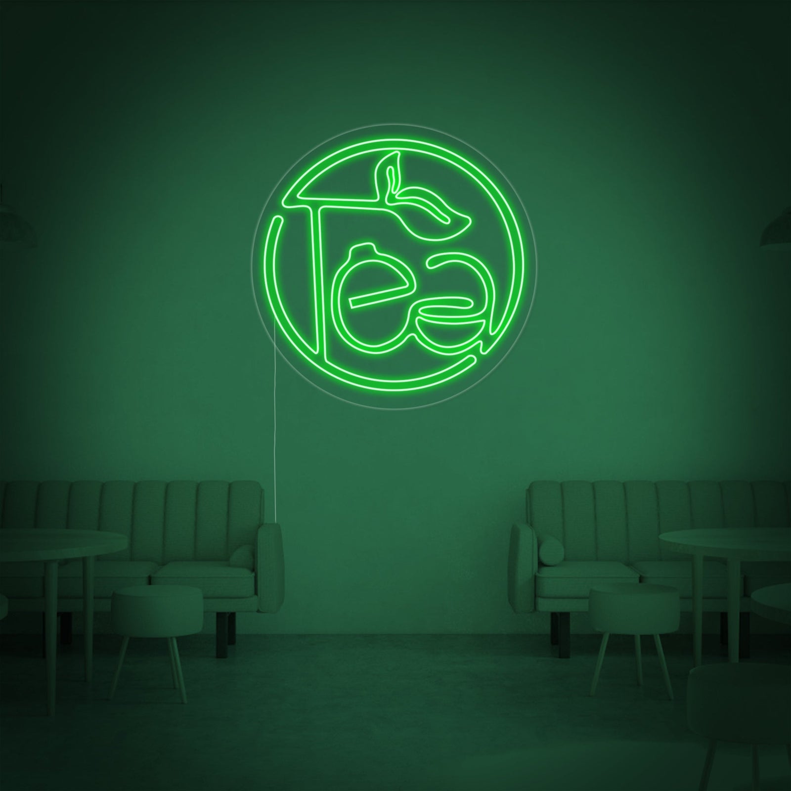 Close-up view of the 'Green Tea' neon sign, showing the detailed craftsmanship of the glowing green tubes and clear backer, illuminating a stylish, modern room.