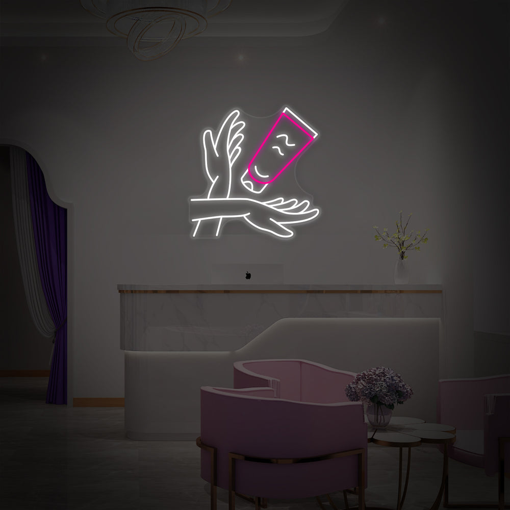 An illuminated blue "Hand Care" neon sign with a hand graphic, shown against a plain white studio background.