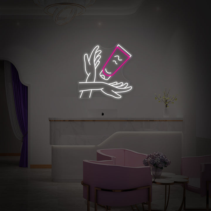 An illuminated blue "Hand Care" neon sign with a hand graphic, shown against a plain white studio background.