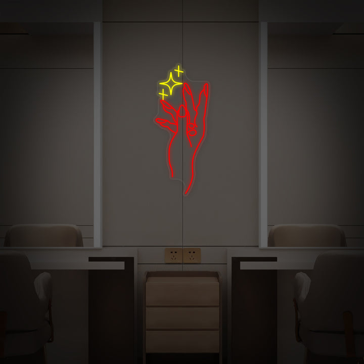 A vibrant neon sign for a nail salon, displaying a stylized hand with painted nails and a circular accent, mounted on a clear acrylic backing over a wall in a chic studio environment.