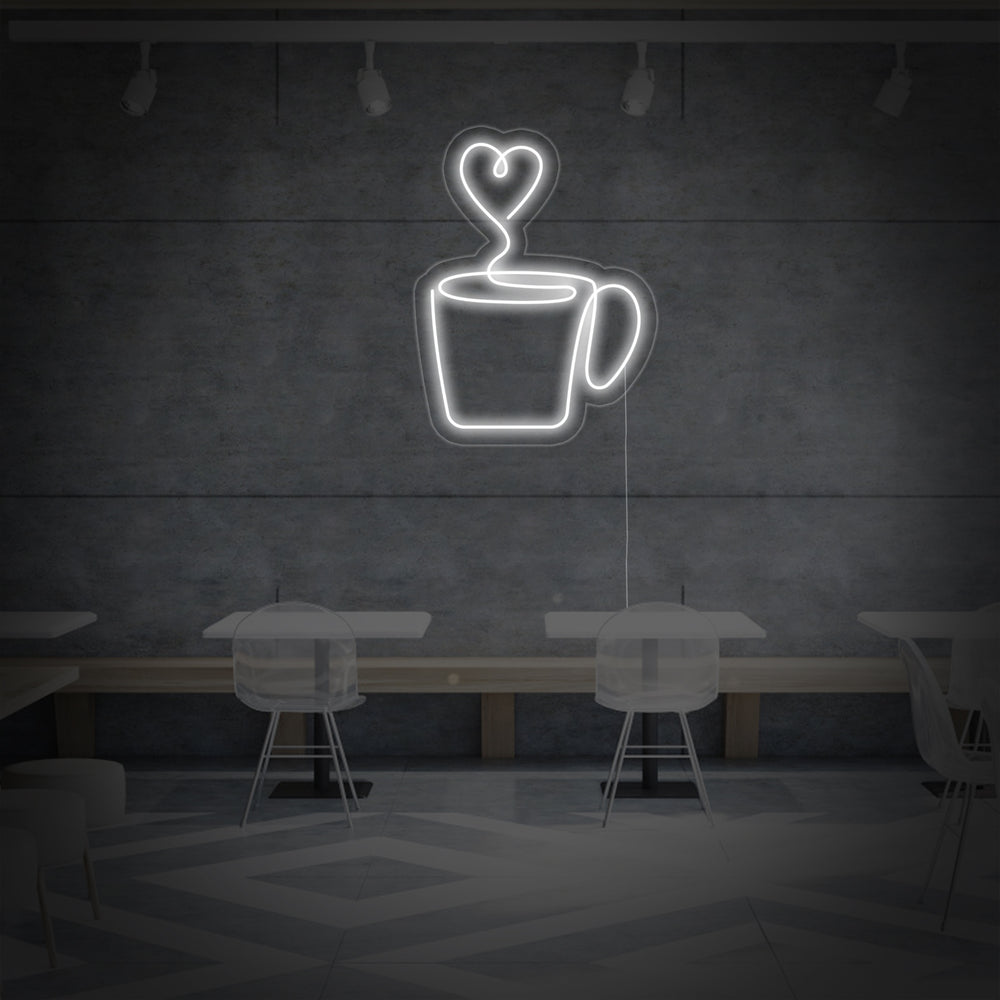 The 'Heart Coffee' neon sign illuminated on a rustic brick wall, displaying its intricate design of a heart-shaped cup and swirling steam.