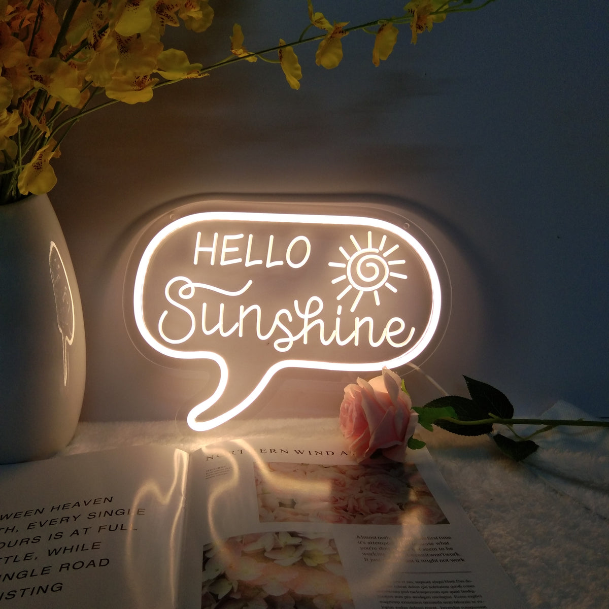 Close-up of the dimmable 'Hello Sunshine' mini neon sign, highlighting the 3D engraved script lettering lit by yellow neon tubes.