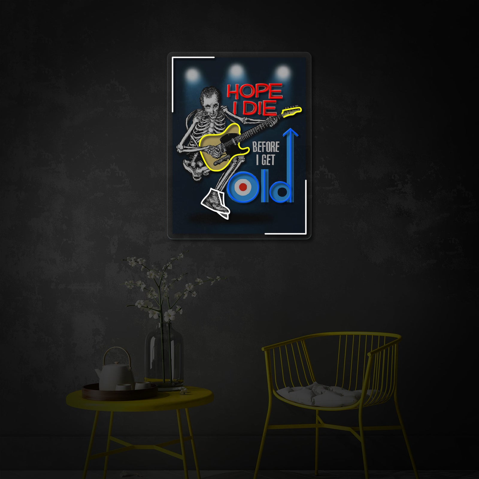 A close-up view of the 'Hope I Die Before I Get Old' neon sign, showing the textured UV print background of a punk skeleton and the glowing blue neon tubing against a bedroom wall.