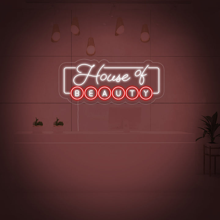 A glowing 'House of Beauty' neon sign is displayed behind a reception desk in a modern beauty salon setting.