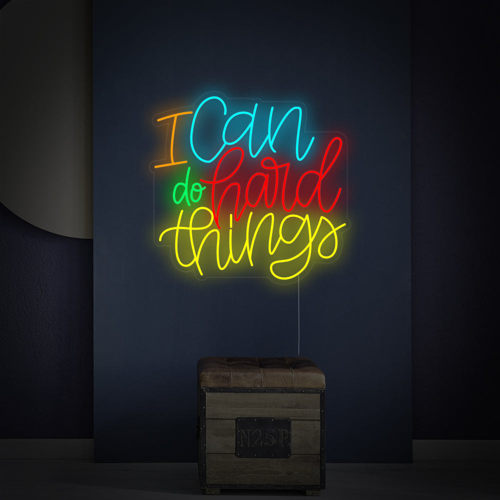 Close-up detail of the 'I Can Do Hard Things' neon sign showing the light tubes on an acrylic backing
