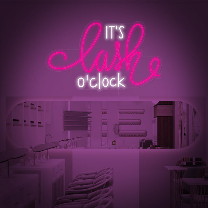 A graphic design mockup of the 'Its Lashes Oclock' neon sign, showing the playful text glowing in pink lines against a background of a modern lash salon interior with a styling chair and wall decorations.