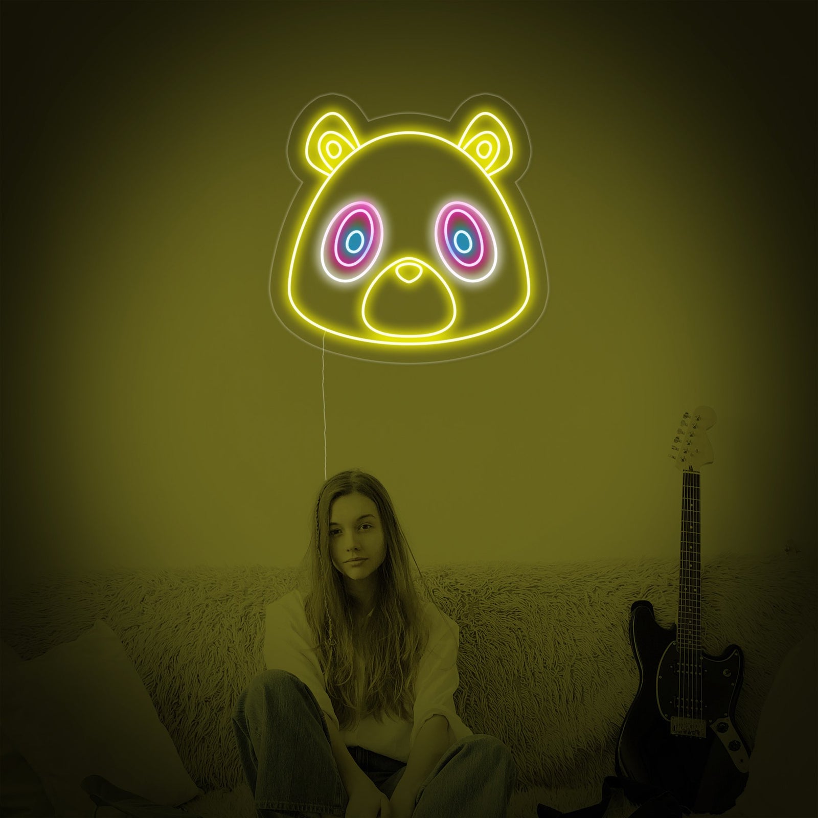 A close-up photograph of the 'Graduation Bear' neon sign, clearly showing the glowing neon tubing shaped into an adorable bear cub with a graduation cap on a clear acrylic background.