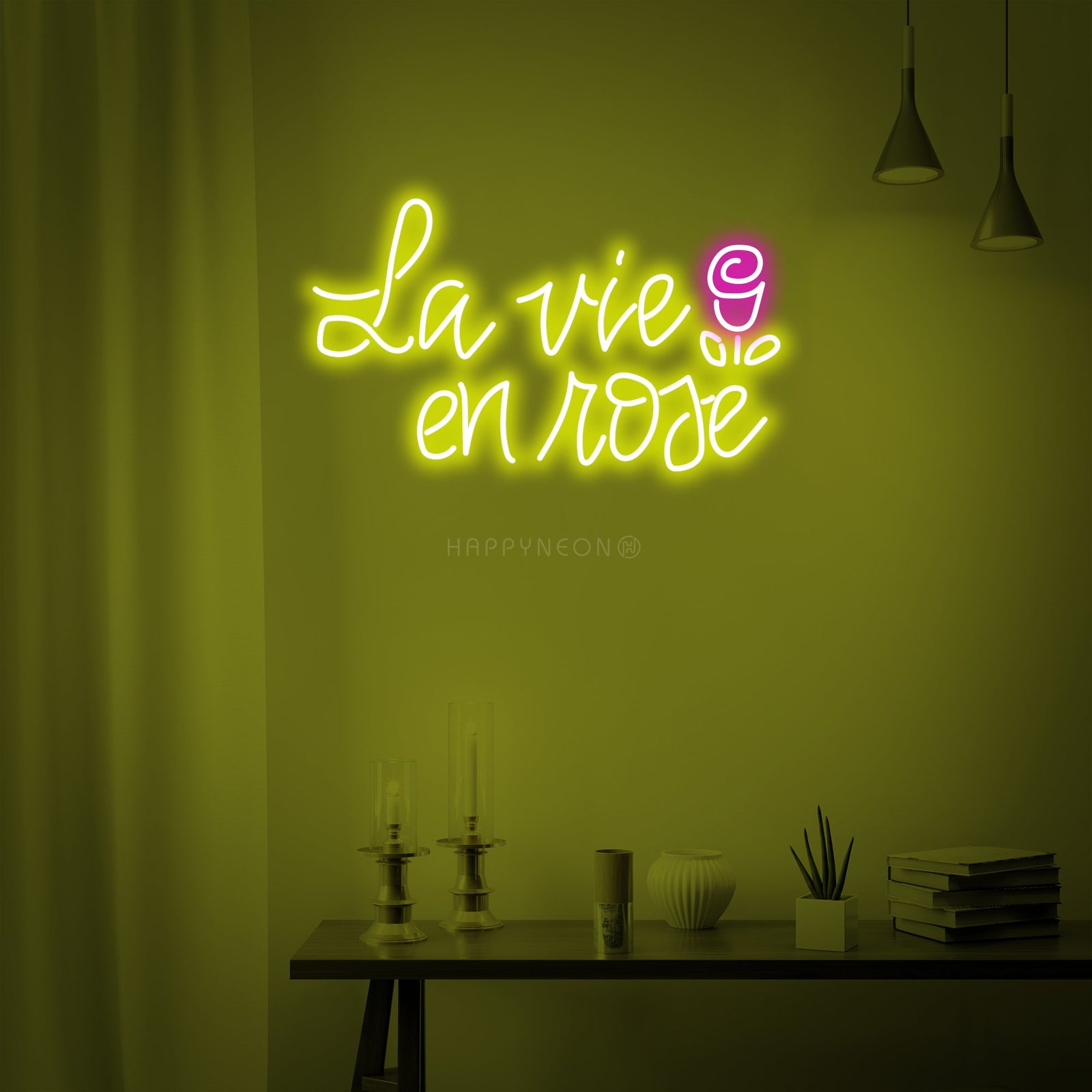 A close-up view of the 'La vie en rose' neon sign, showing the detailed glowing script and construction against a wall backdrop.