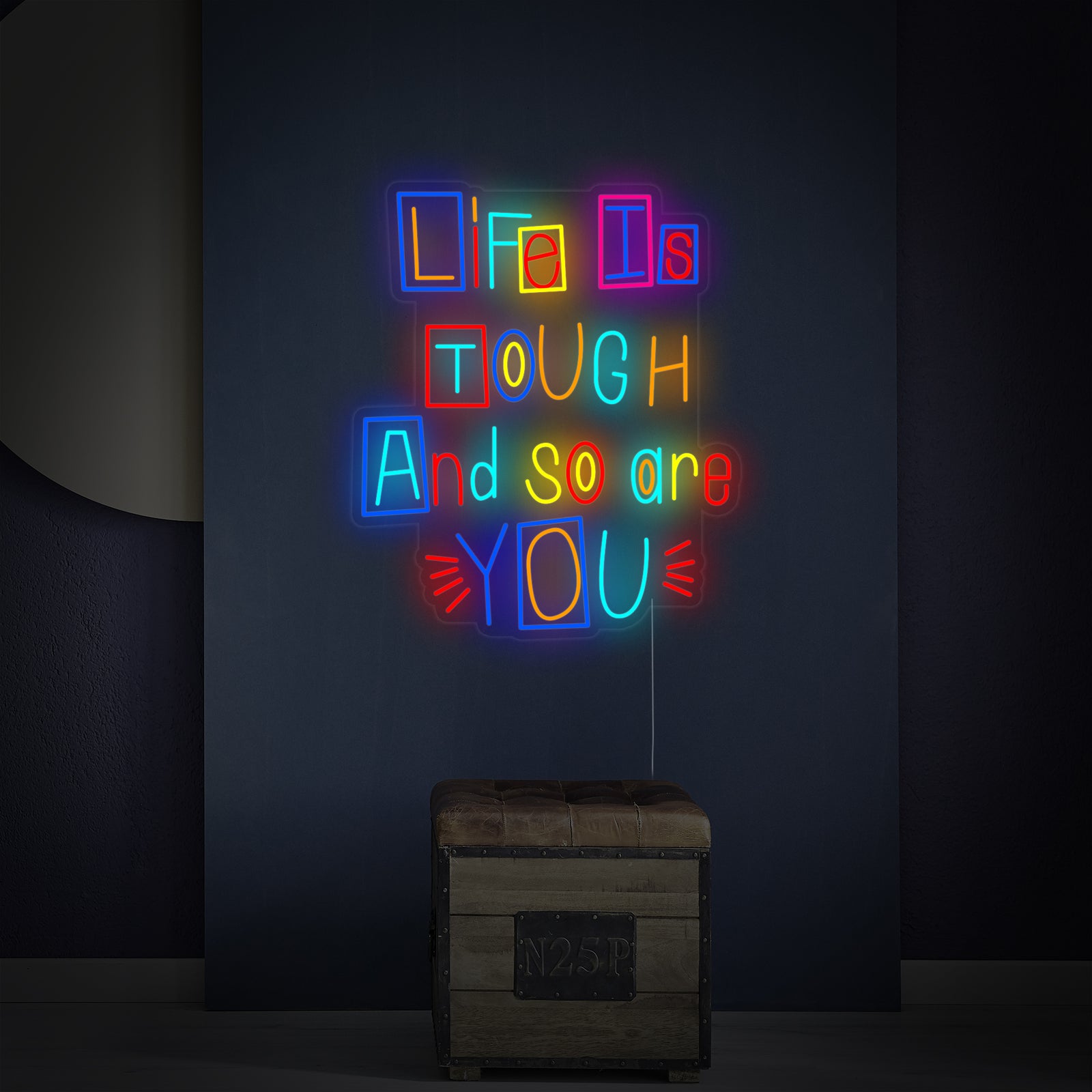 Close-up detail of the 'Life is Tough and So Are You' neon sign showing its craftsmanship and lit appearance.