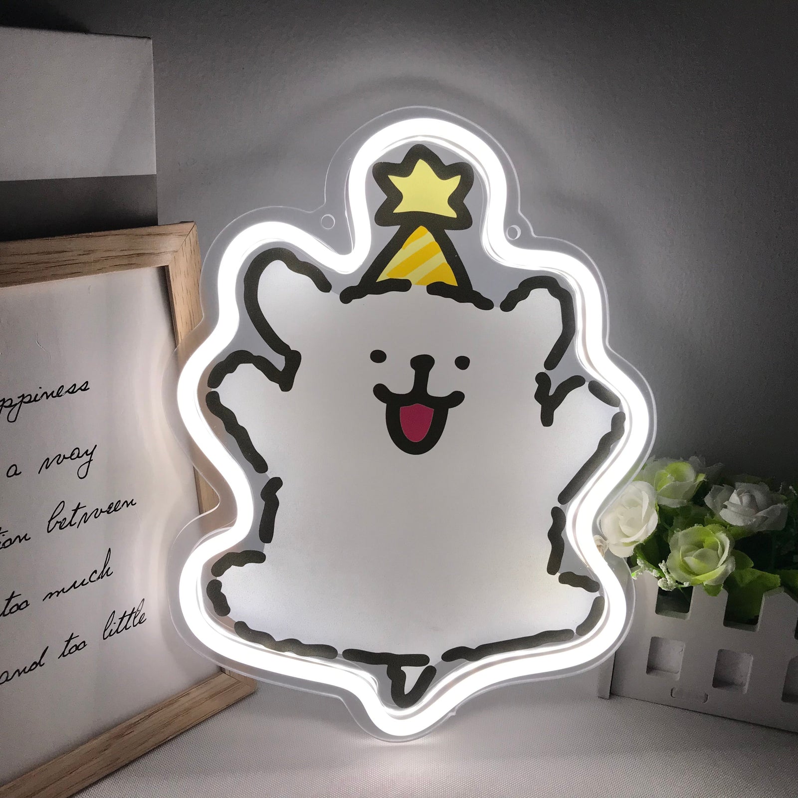 Cartoon Maltese puppy mini neon sign lit up against a rustic brick wall