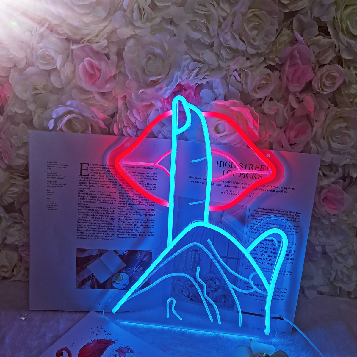 Detail view of the lit-up red 'Lips Be Quiet' USB neon sign clearly showing the etched clear acrylic backing and red neon light tubes.