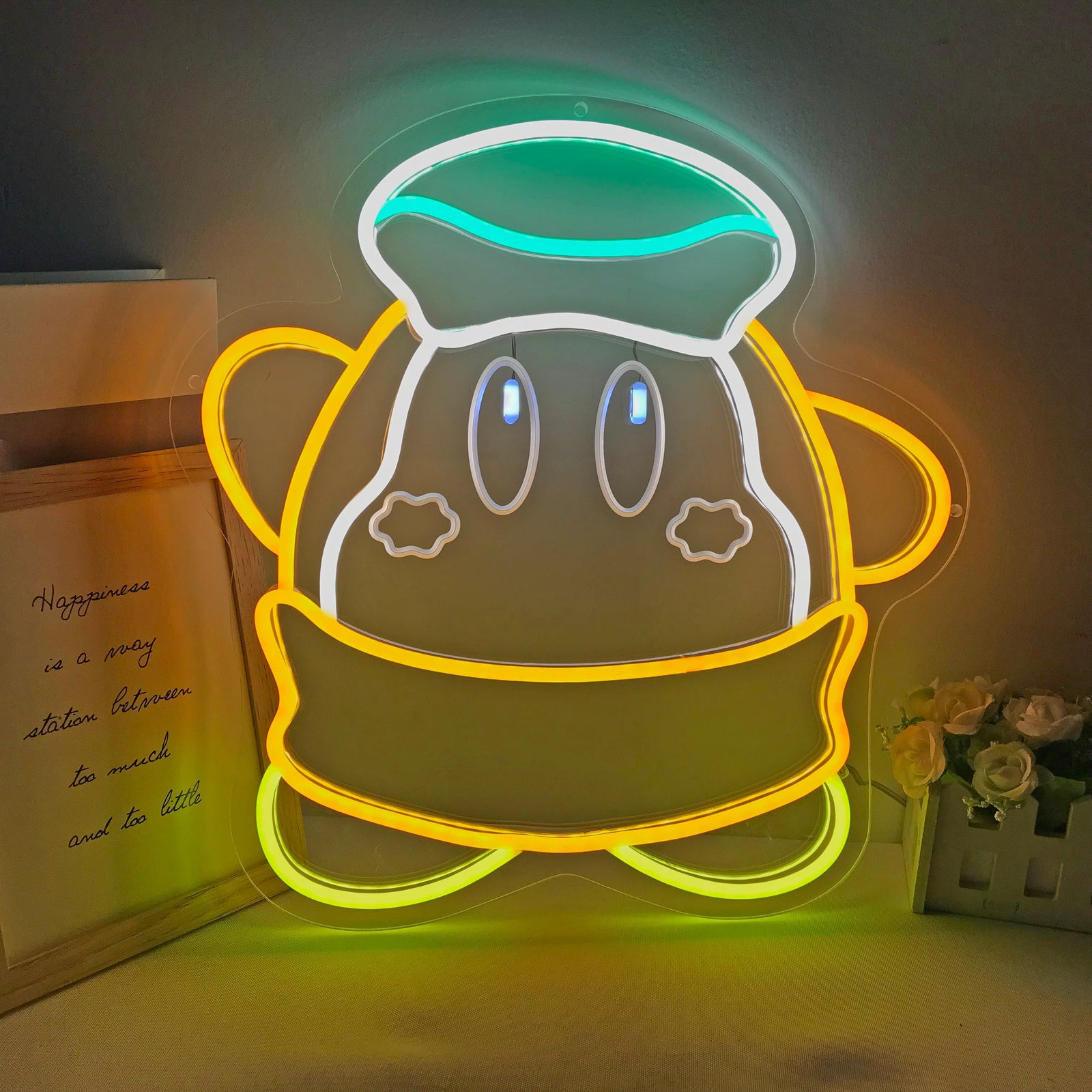 Illuminated Luma Star mini neon sign showing a yellow star shape on a gaming-themed desk setup