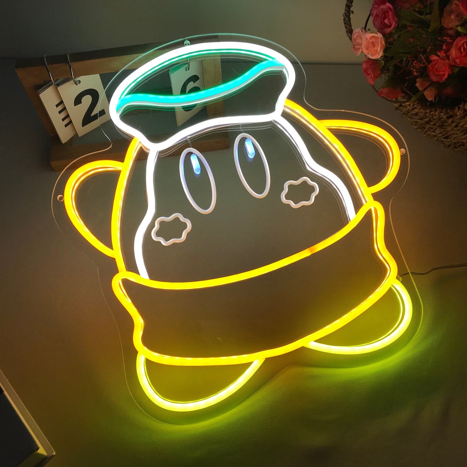 Close-up of the Luma Star mini neon sign showing the lit yellow tubing and transparent acrylic backing