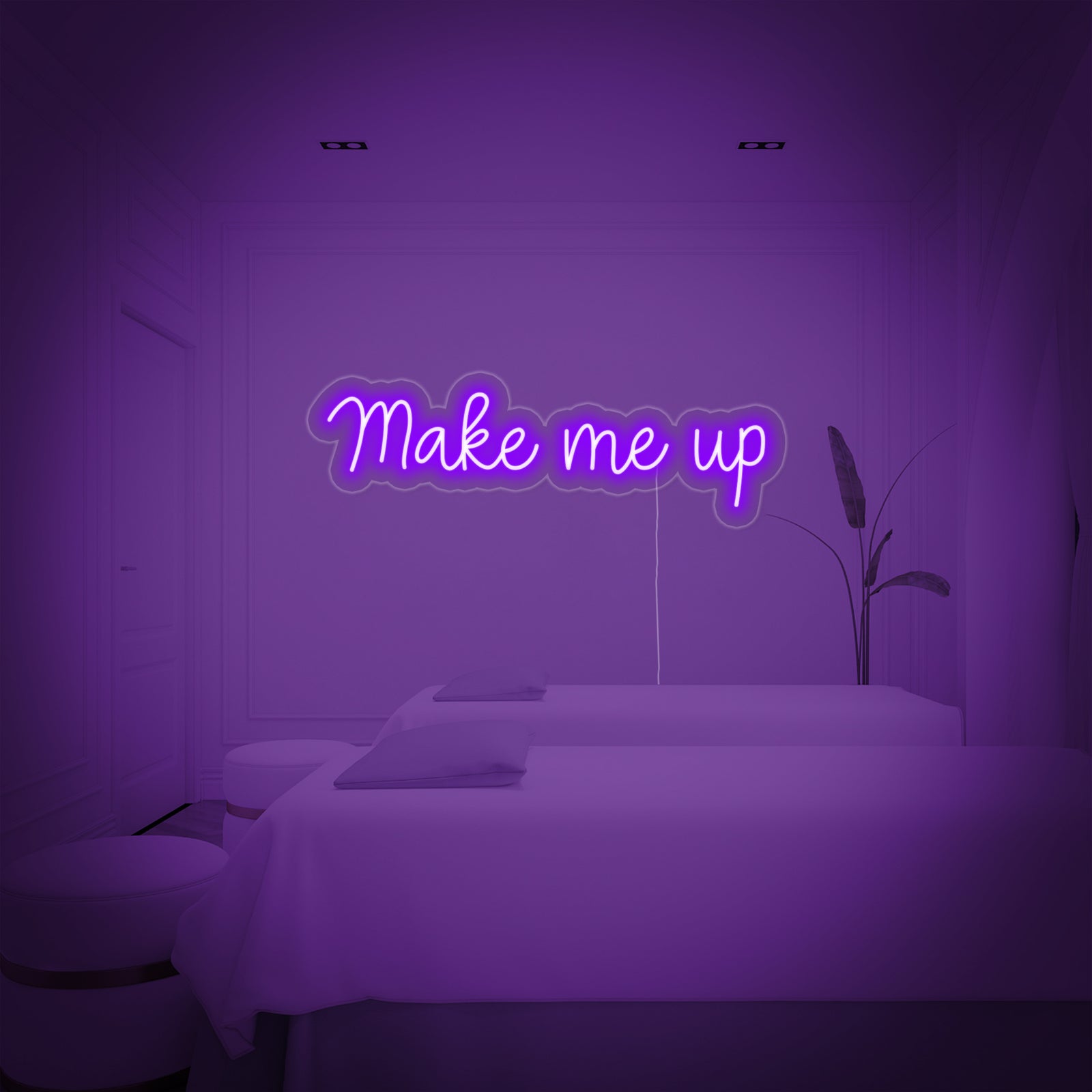 Close-up photograph of the 'Make Me Up' neon sign, showing the clear script lettering mounted neatly on a textured white wall.
