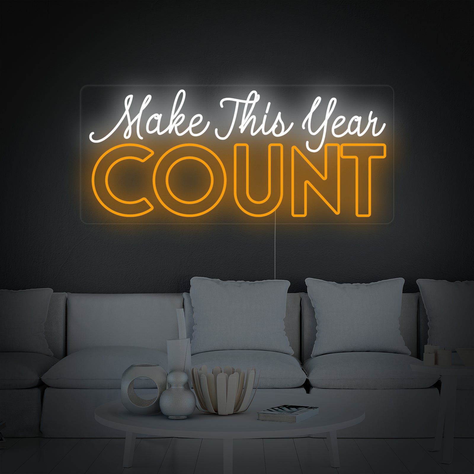 Clear view of the 'Make This Year Count' neon sign letters and transparent backing against a plain, neutral background.