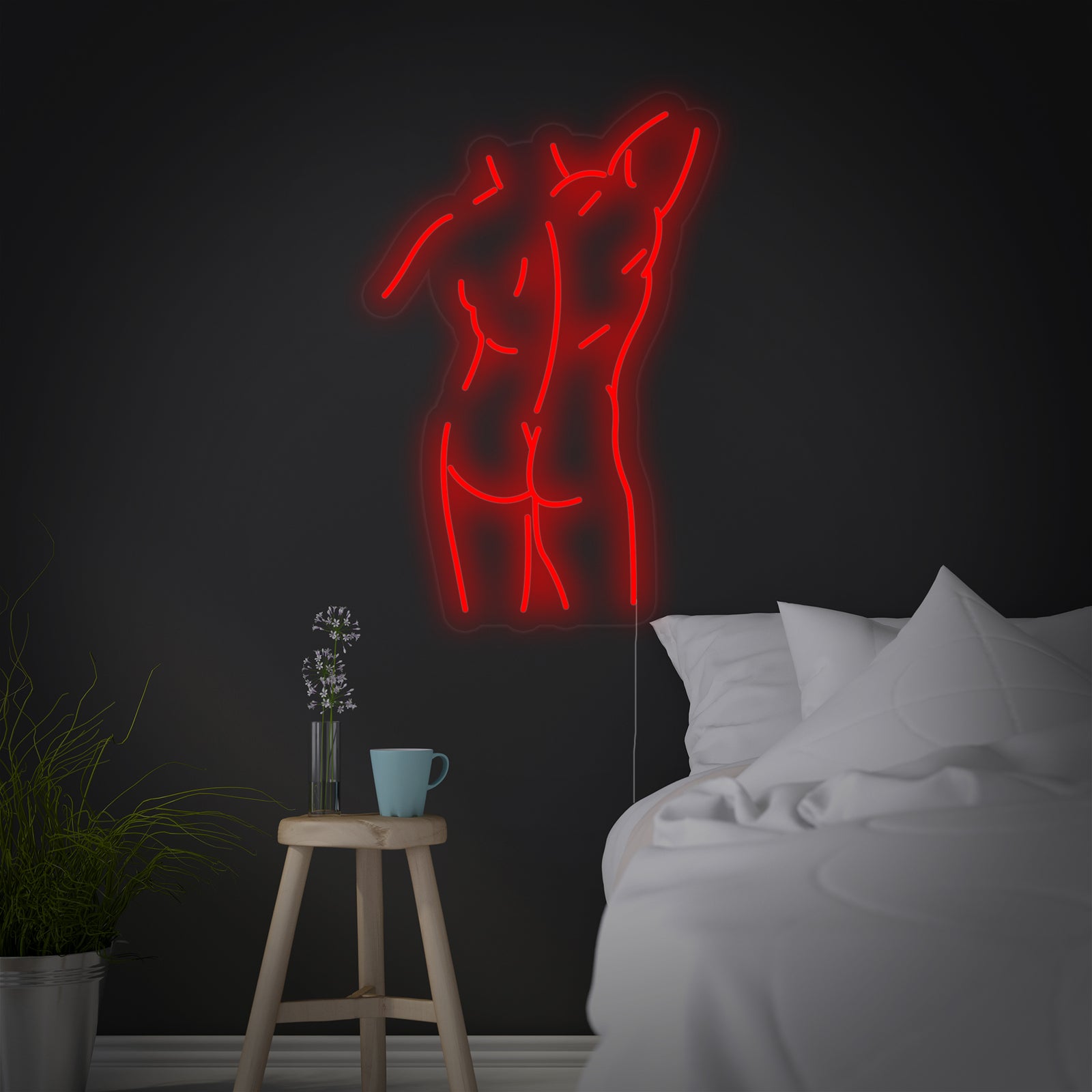A glowing blue neon sign depicting a male body outline, mounted on an acrylic backing against a deep blue bedroom wall above a made bed.