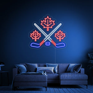 A perspective view of the 'Maple Leaves With Crossed Hockey' neon sign, showing the clear acrylic backing and hanging wire.