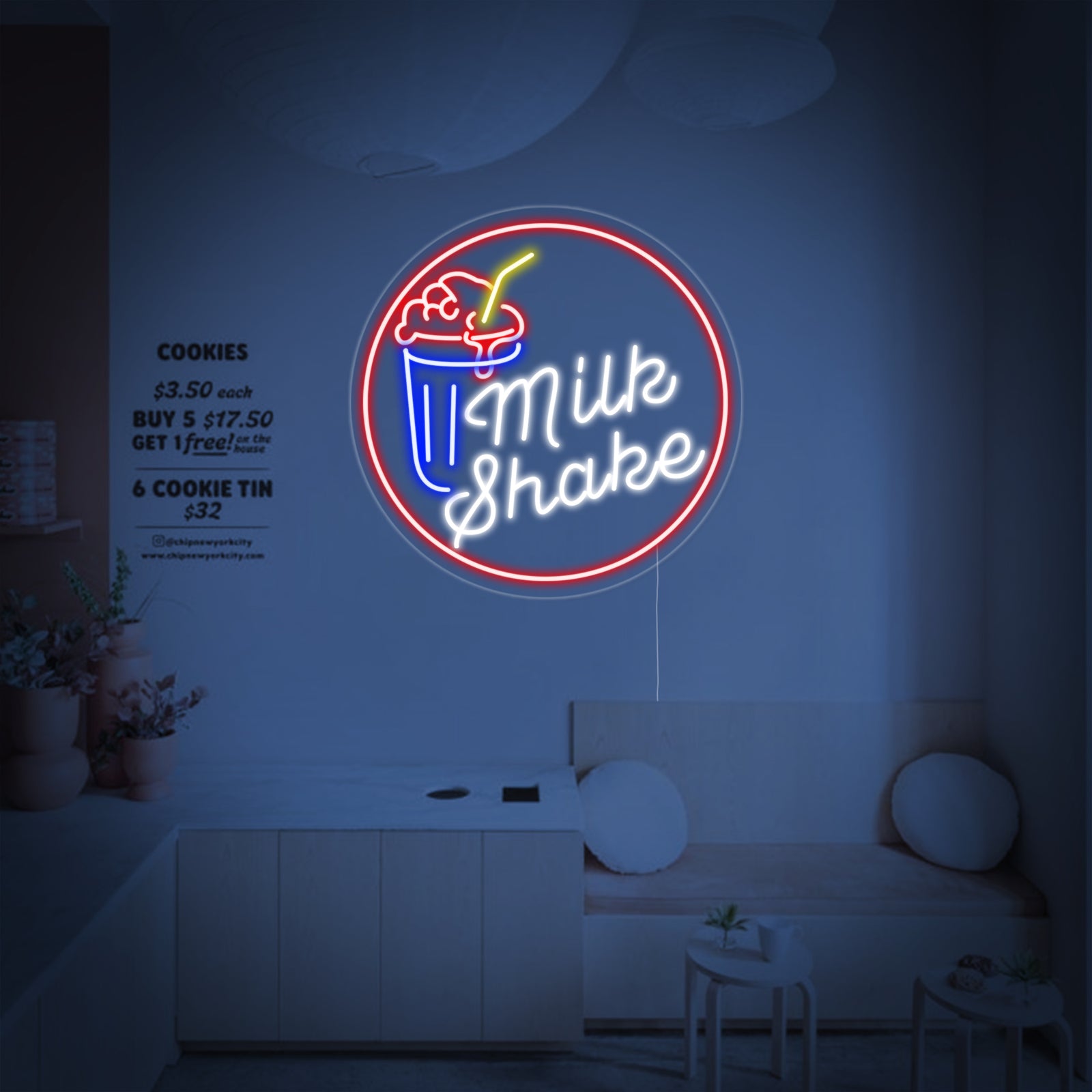 A front view of the 'Milk Shake' neon sign with visible light tubes and acrylic backing, mounted on a plain wall.