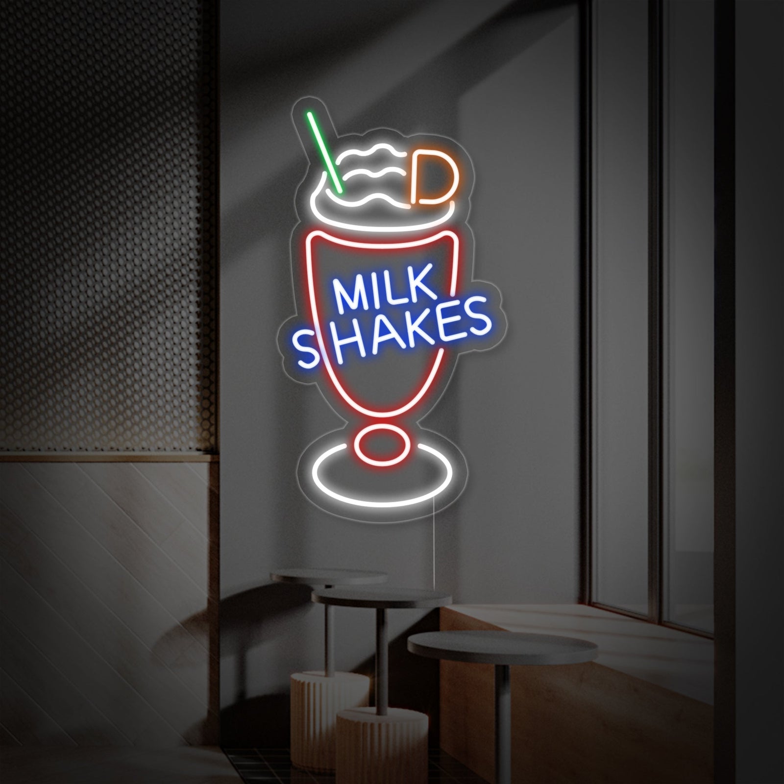 A detailed view of the glowing 'Milk Shakes' neon wall decor, mounted on clear acrylic with a graphic of a milkshake glass.
