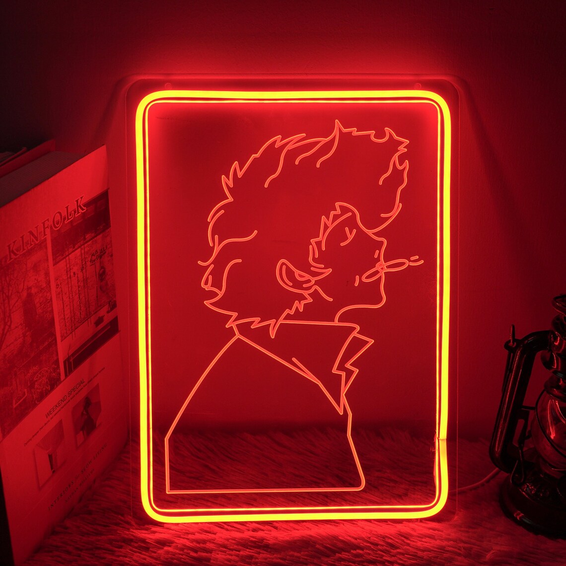 Stylized graphic mockup of the Sailor Moon mini neon sign showing a glowing character outline on an acrylic backplate, positioned on a desk with fictional props.