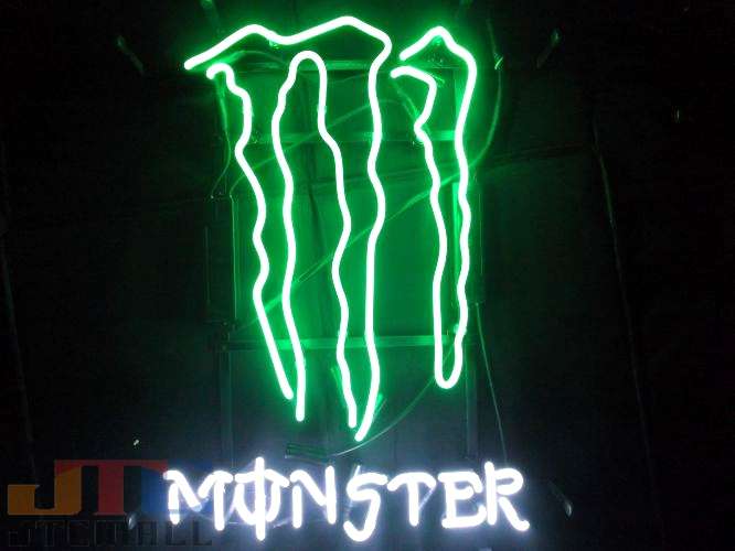Close-up photograph of a fabricated Monster claw neon sign showcasing the glass tubing, electrical wiring, and mounting frame.