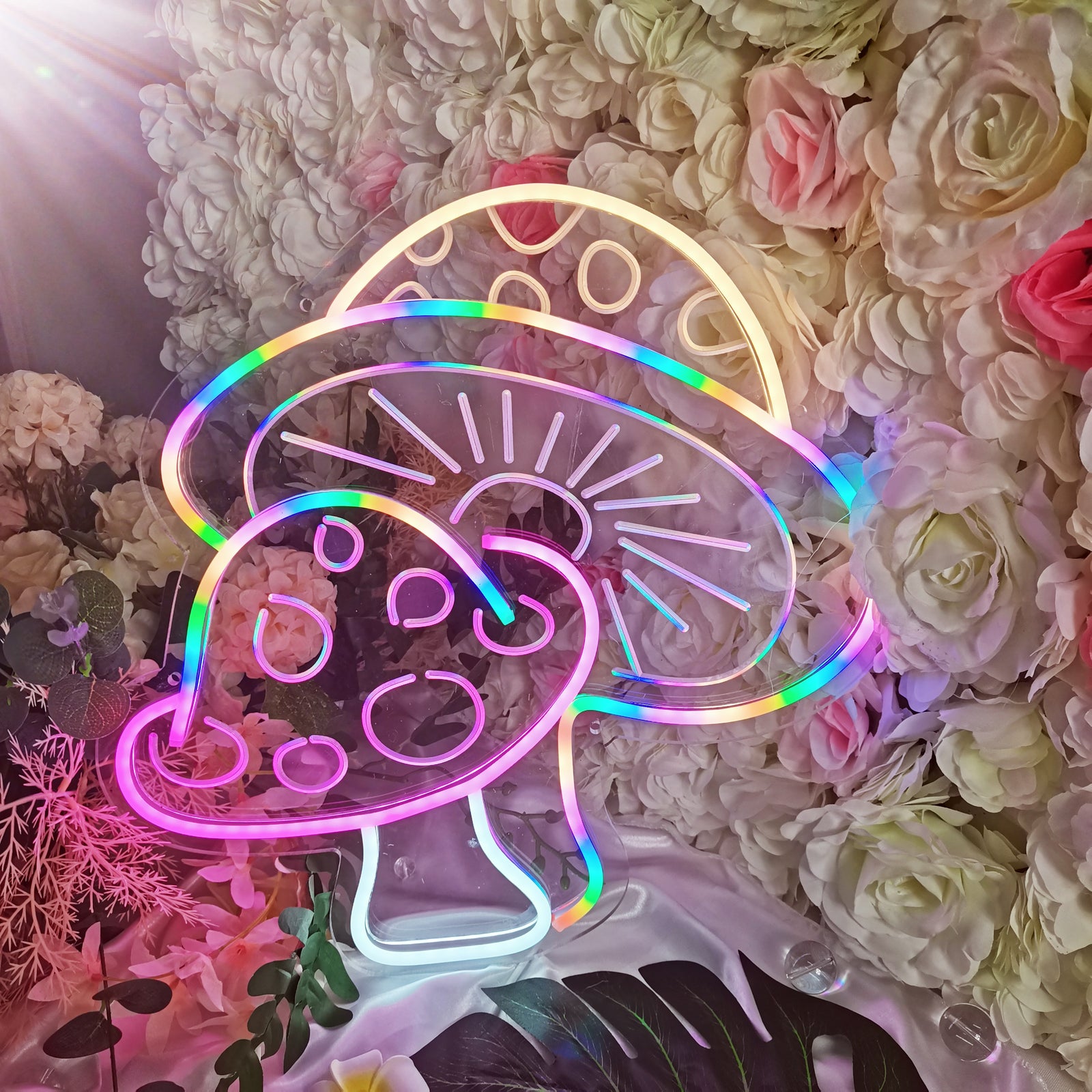 Detailed shot of the multi-color fabrication on the Mushroom USB Mini LED Neon Sign set against a floral background.