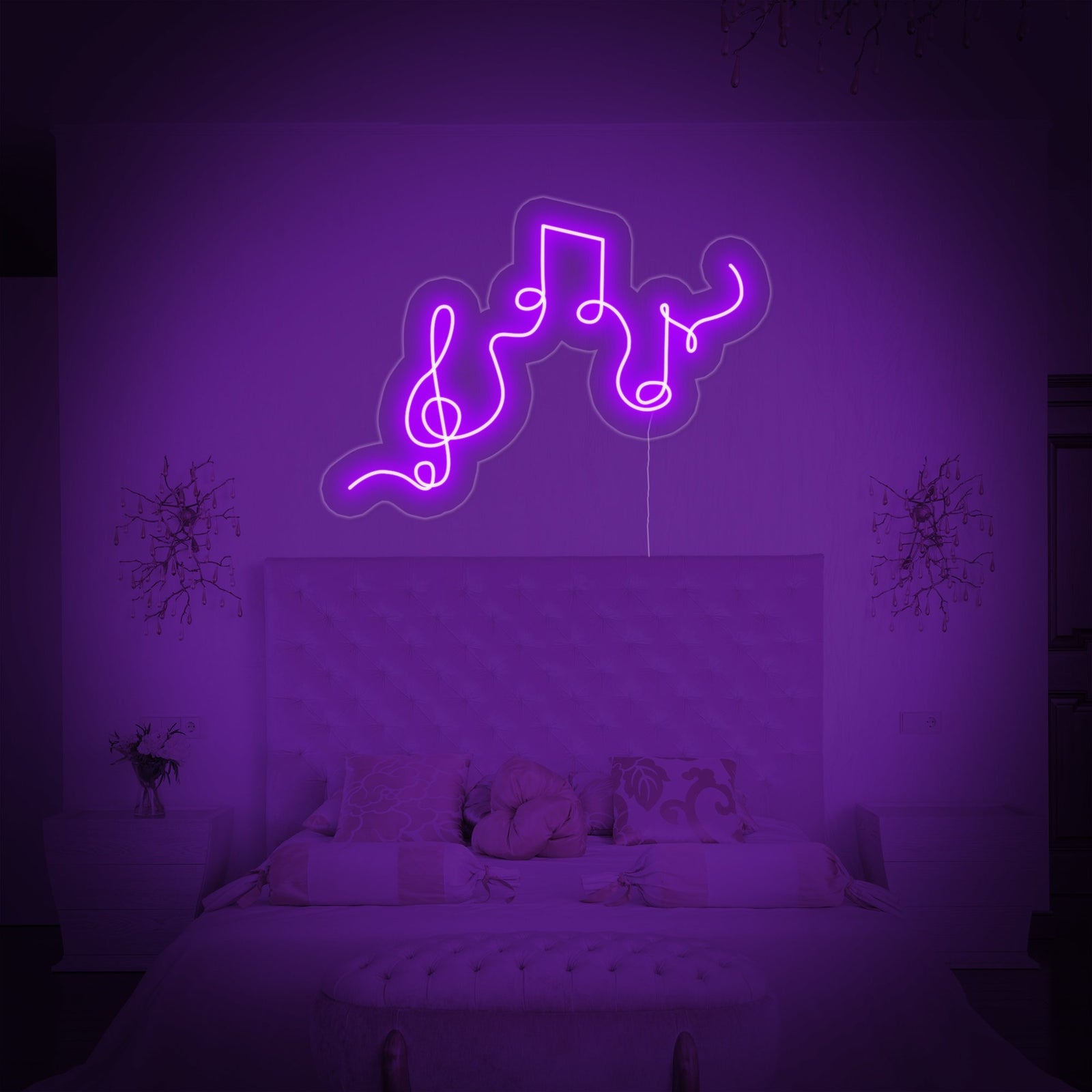 A glowing blue and white neon sign shaped like a musical staff with notes, mounted above a small keyboard in a music studio corner.