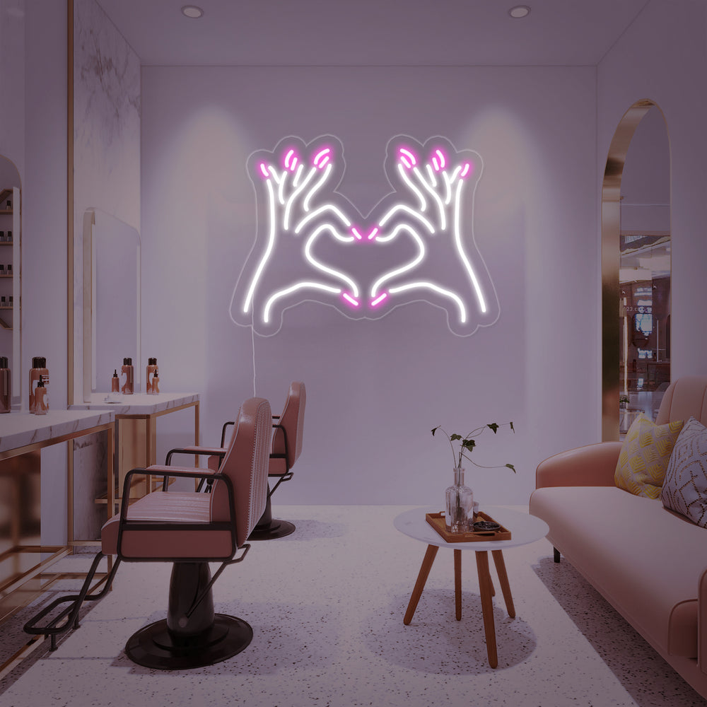 A vibrant 'Nail Salon' neon sign hangs in a bright, contemporary salon interior above comfortable manicure chairs.