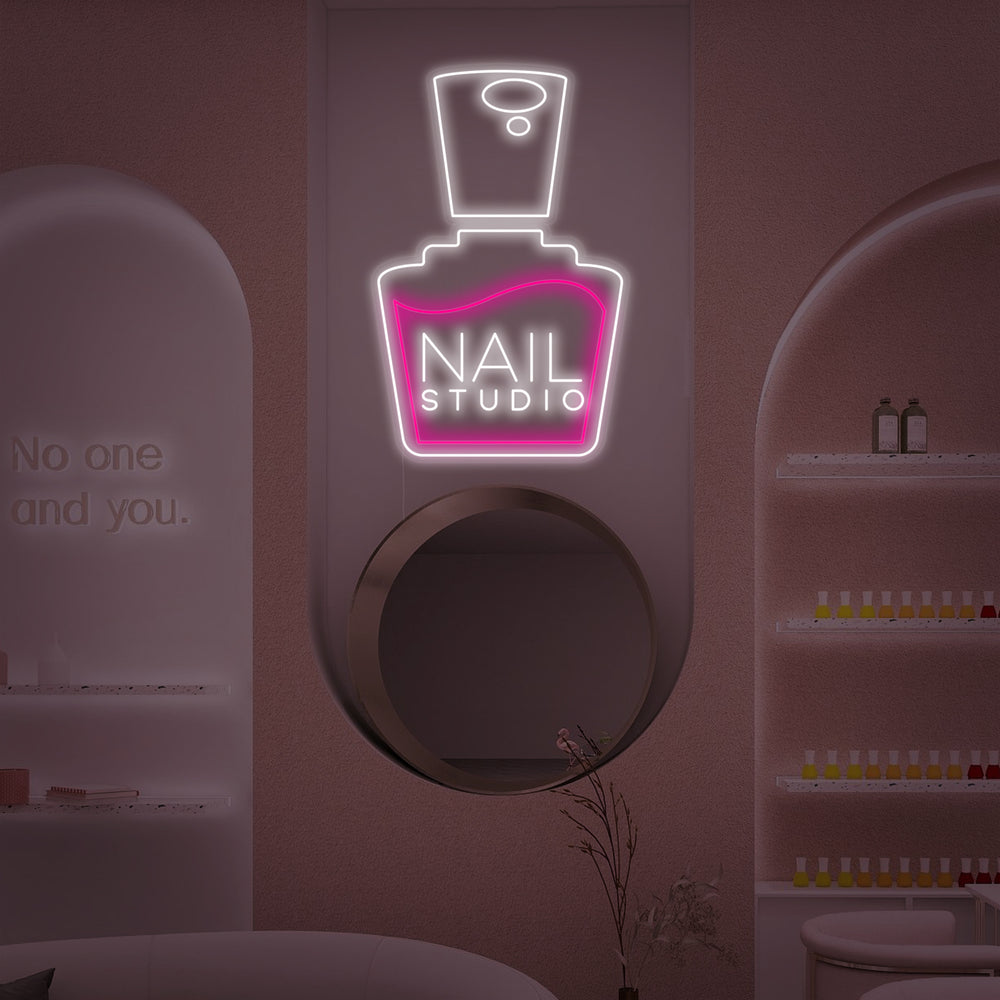 Flat graphic design view of the 'Nails Studio' neon sign featuring stylized cursive text and subtle glow effect.