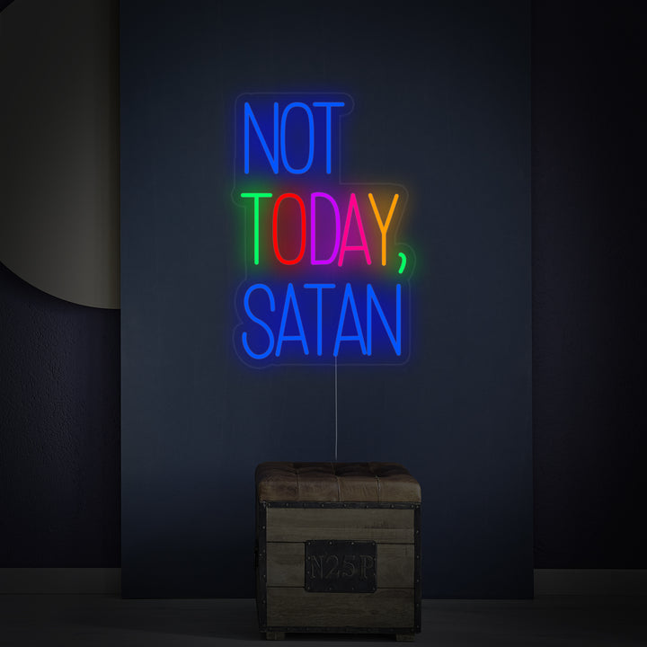 A close-up view of the 'Not Today Satan' neon sign, showing the detailed lighting, clear acrylic backboard, standoffs, and power cord.