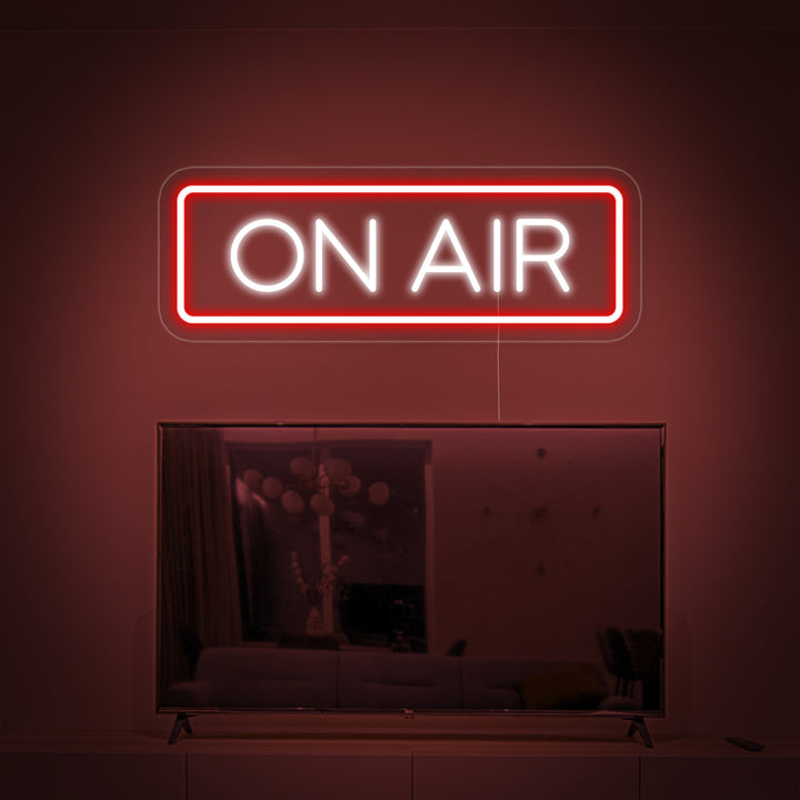 A perfectly composited bright red ON AIR neon sign glowing above a television in a modern living room.