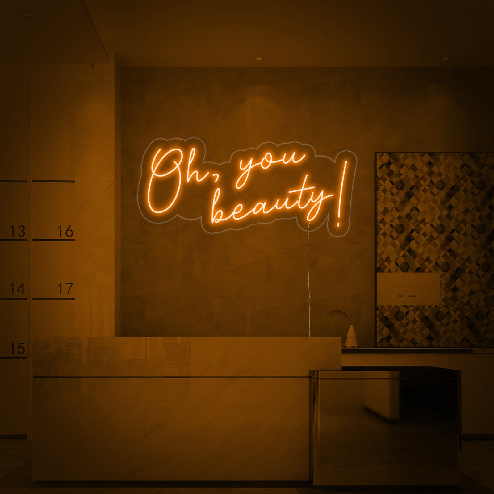 The 'Oh You Beauty' neon sign is beautifully integrated into a modern salon reception area wall.