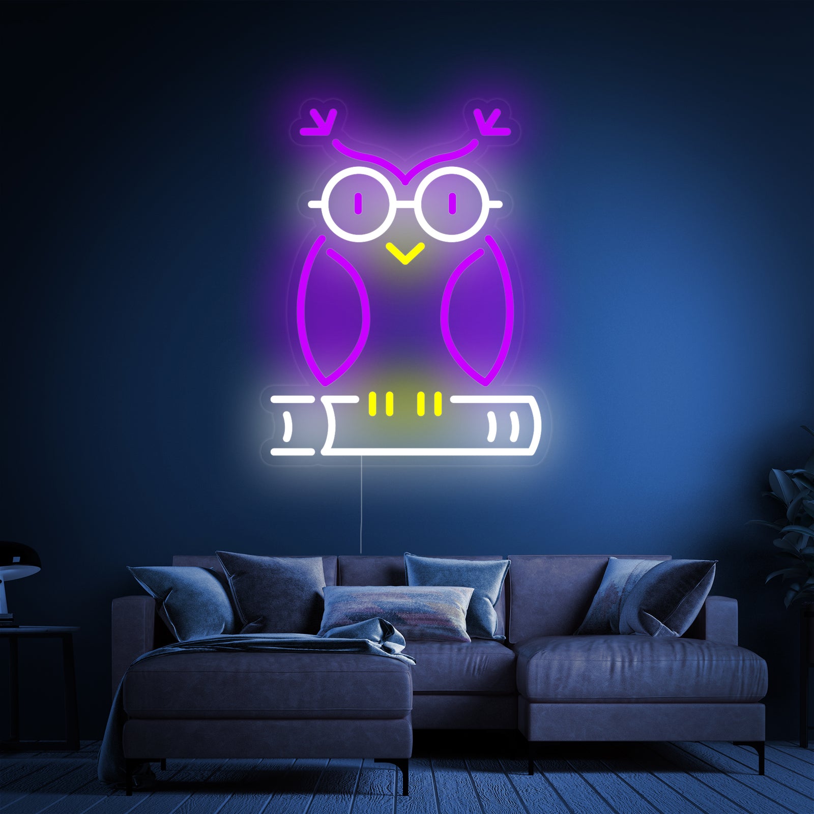 A glowing neon sign depicting a detailed design of an owl standing on a book, casting a warm white light.