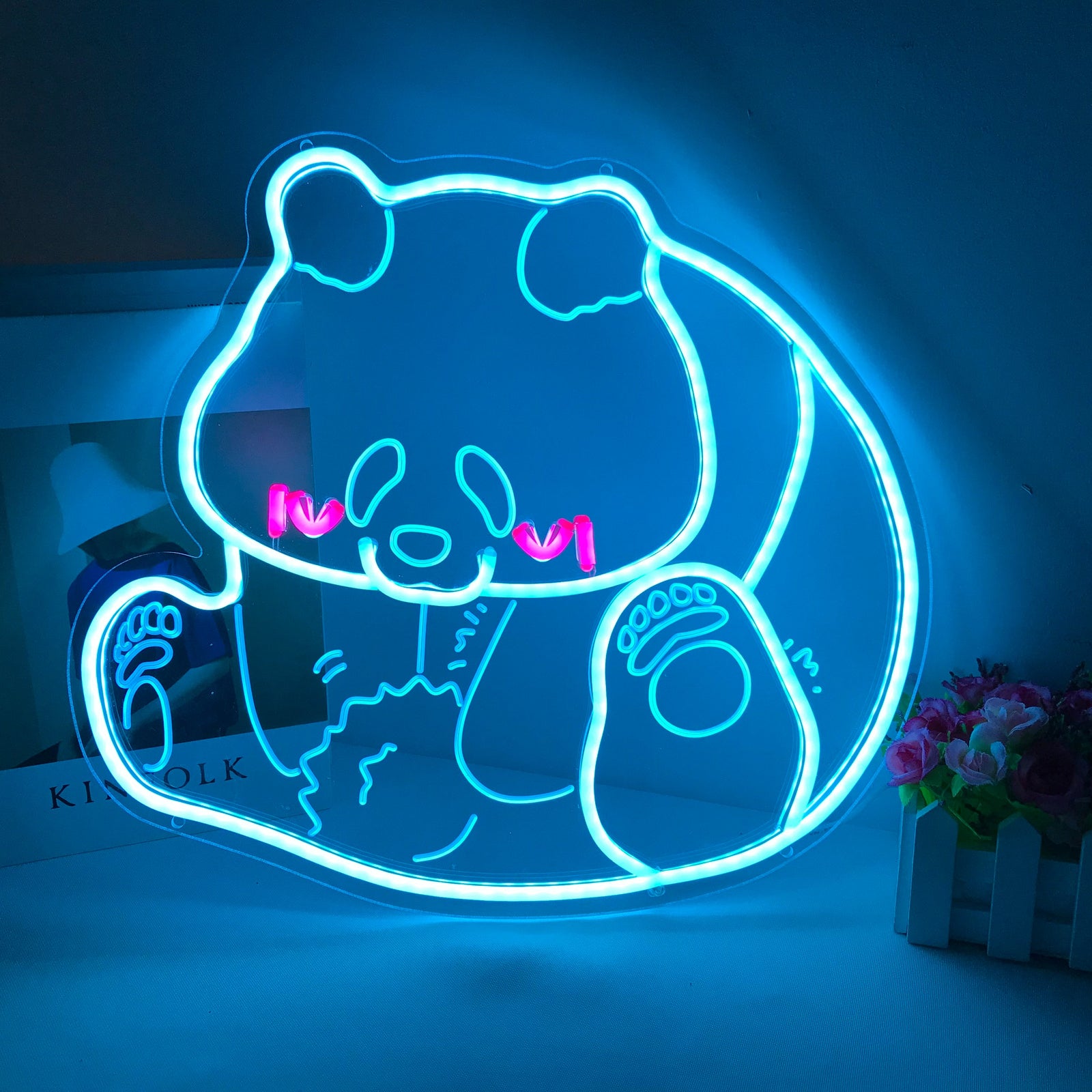 Close-up of the lit "Panda, Cartoon" mini neon sign showing the blue and white colors and silicone tubing.