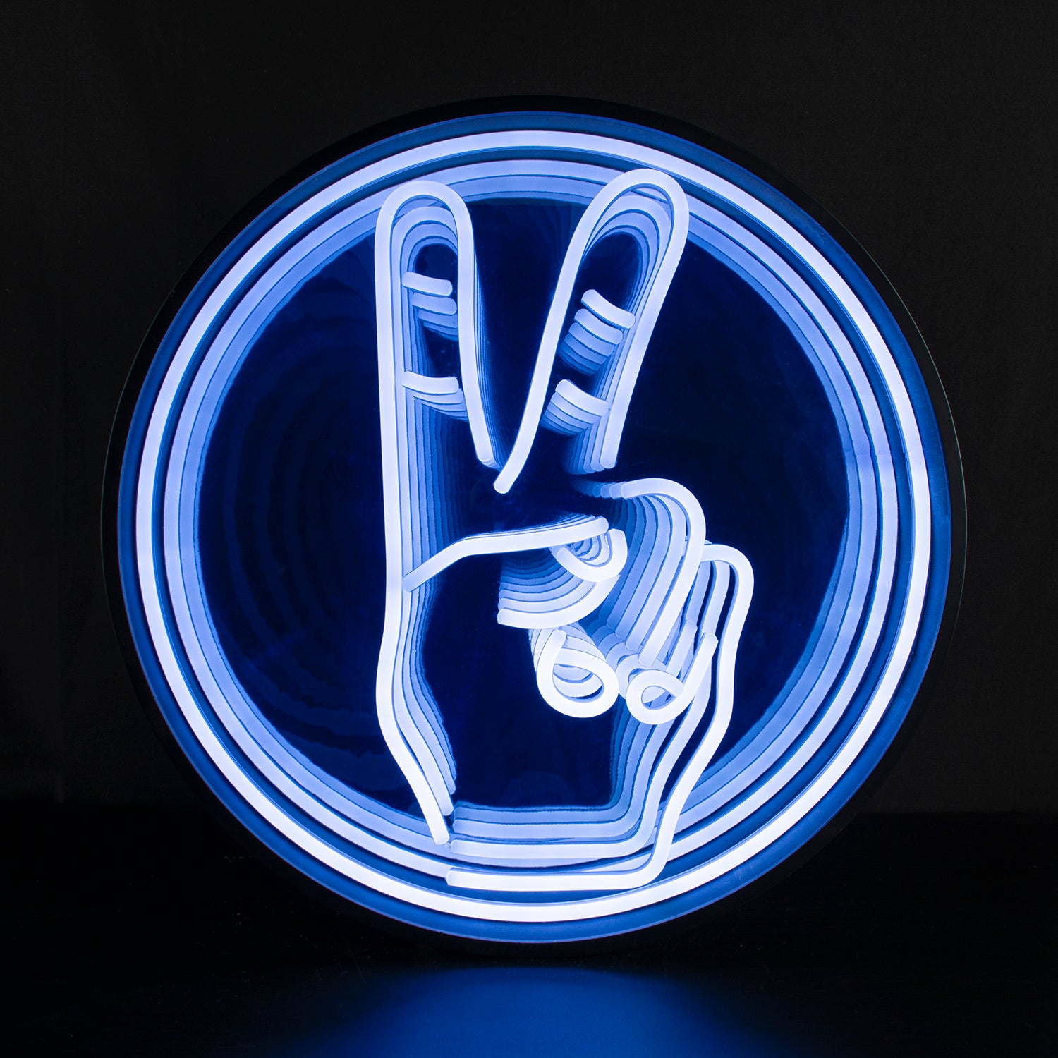 Photograph of the 3D infinity peace sign neon sign glowing with deep red concentric rings and central peace symbol, casting reflections, hanging on a wall.