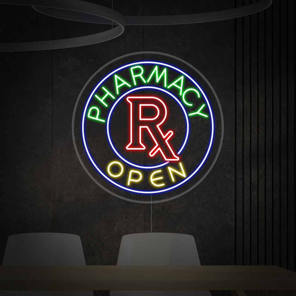 A professional green and white Pharmacy Open neon sign on a clear acrylic backer, glowing brightly against a neutral background.