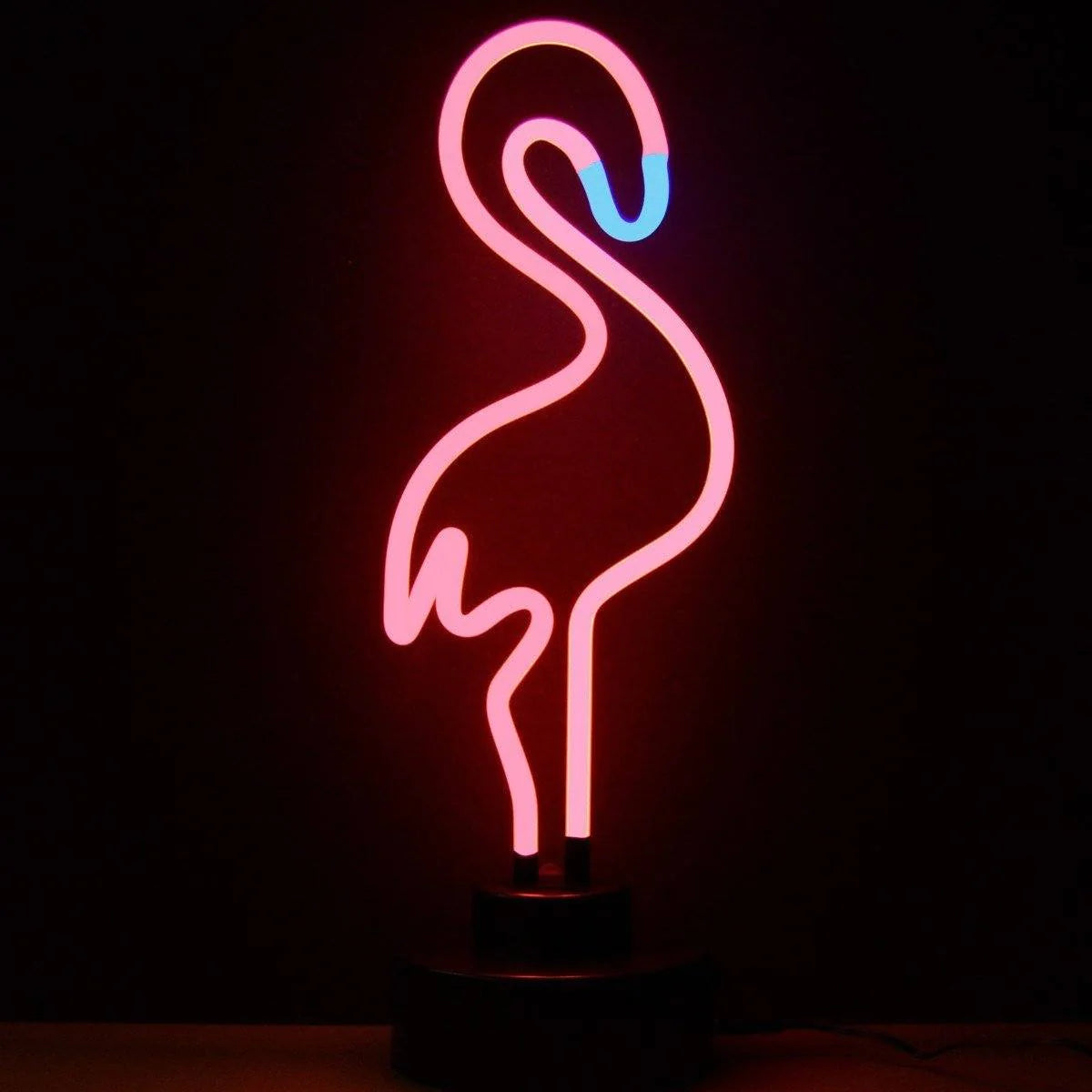 A illuminated real glass pink flamingo table neon sign mounted on a black base.