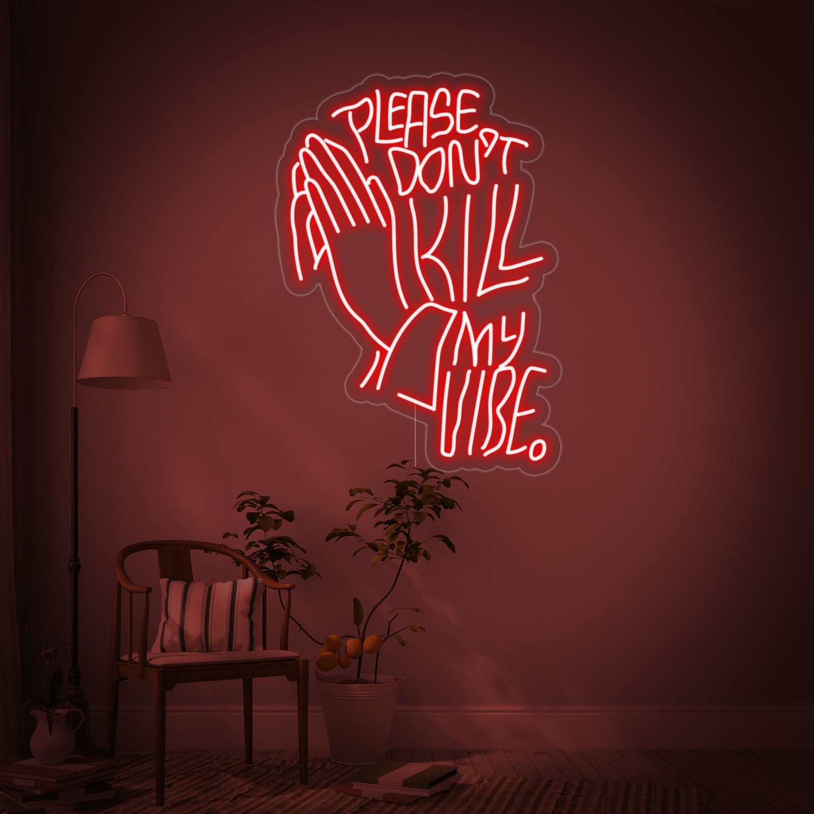 The 'Please Dont Kill My Vibe' neon sign glowing above a comfy chair and a lamp, adding a personalized touch to a modern living room.