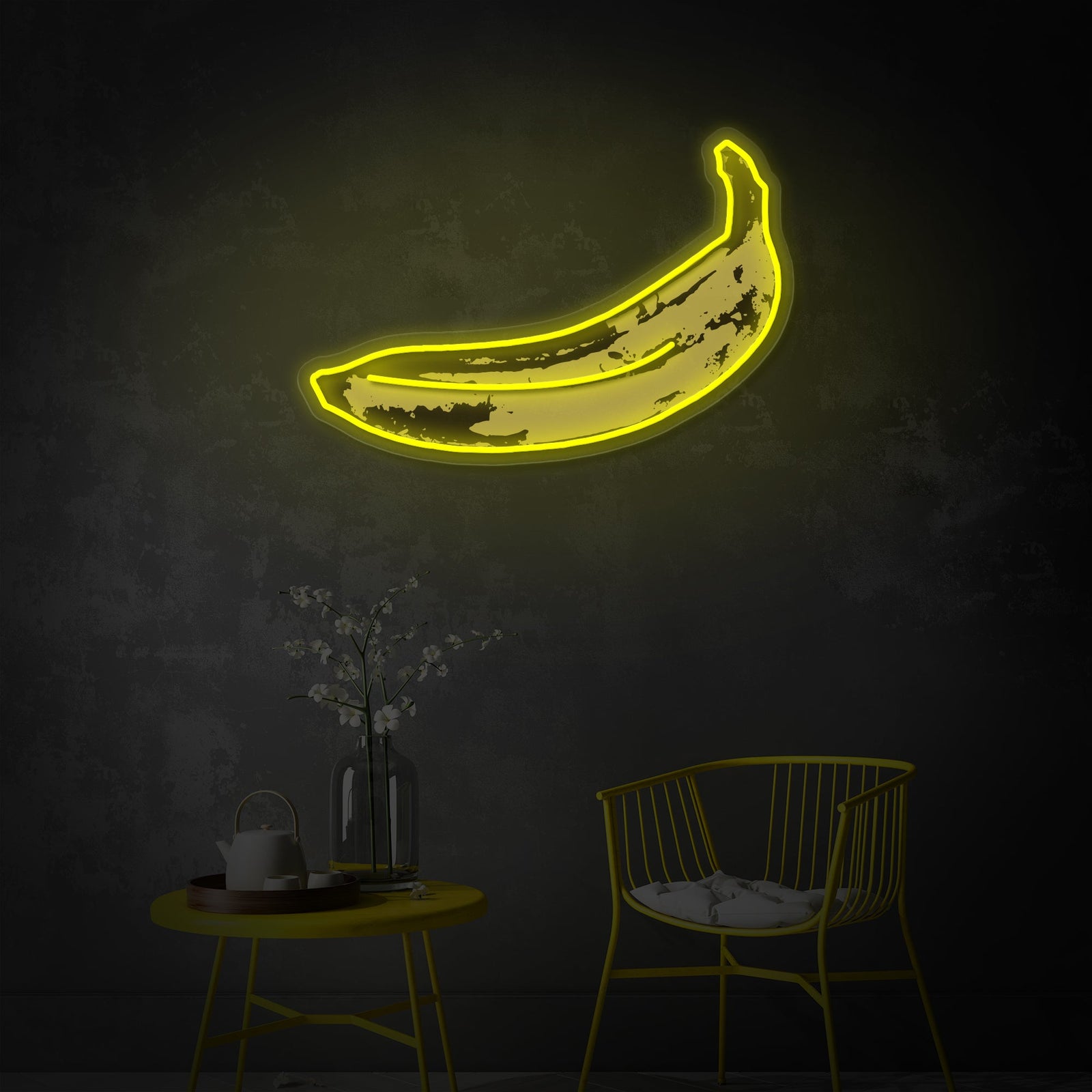 Close-up photograph of a fabricated Pop Art Banana UV printed neon sign glowing brightly on a textured grey wall.