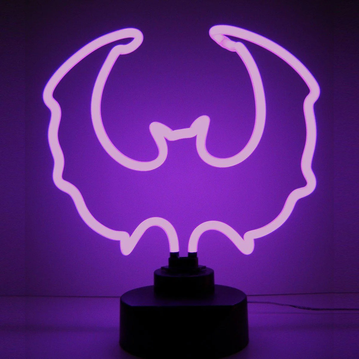 Purple Bat real glass neon tube sign on a black table stand, glowing against a dark background